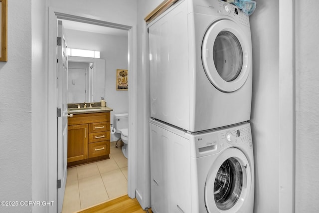 824 O Pl, Anchorage, AK 99501 - laundry room with stacked washing machine and dryer and light tile patterned floors