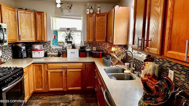 7191 S Yohn Bay Pl, Wasilla, AK 99623 - kitchen with a sink, decorative backsplash, appliances with stainless steel finishes, and light countertops