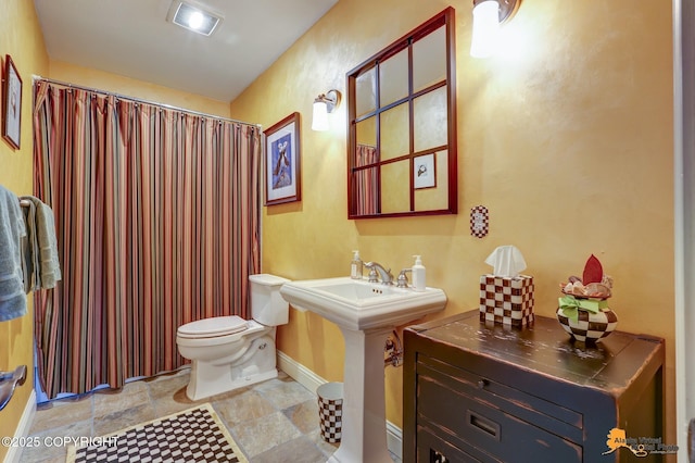 16971 Mount Mckinley View Dr, Anchorage, AK 99516 - full bath featuring toilet, baseboards, stone finish floors, and a shower with curtain