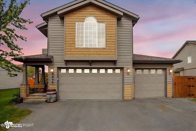 5846 Grand Teton Loop, Anchorage, AK 99502 - view of front of house featuring driveway, an attached garage, and a shingled roof