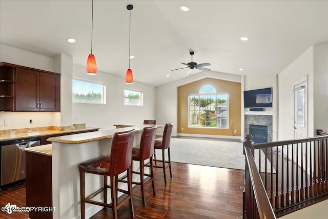 5846 Grand Teton Loop, Anchorage, AK 99502 - kitchen featuring stainless steel dishwasher, dark wood-style flooring, vaulted ceiling, a kitchen island, and decorative light fixtures