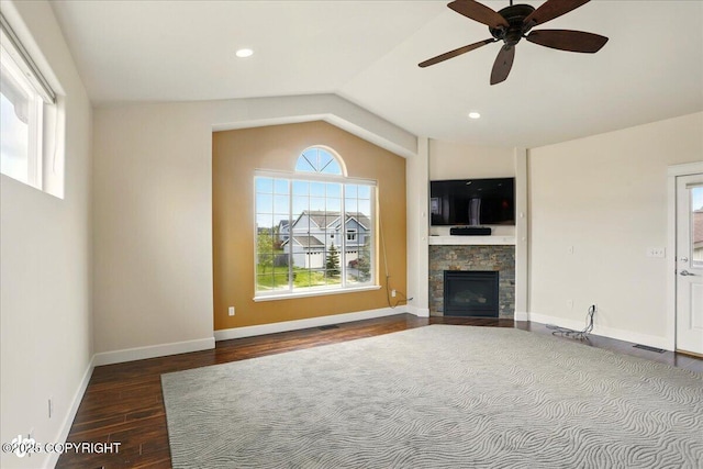 5846 Grand Teton Loop, Anchorage, AK 99502 - unfurnished living room featuring wood finished floors, lofted ceiling, a fireplace, a ceiling fan, and baseboards