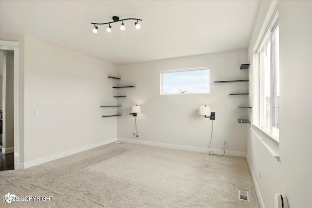 5846 Grand Teton Loop, Anchorage, AK 99502 - laundry room featuring plenty of natural light, carpet flooring, and baseboards