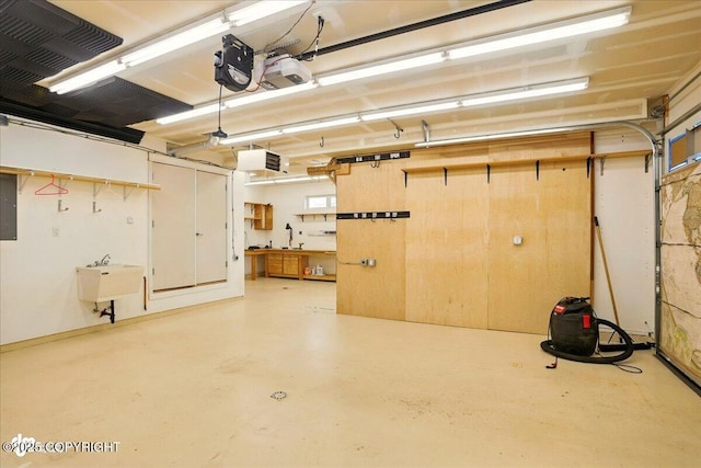 5846 Grand Teton Loop, Anchorage, AK 99502 - garage with electric panel, a sink, a garage door opener, and a workshop area