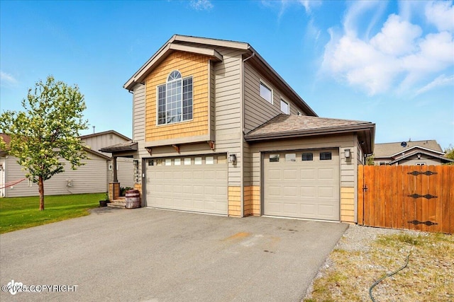 5846 Grand Teton Loop, Anchorage, AK 99502 - traditional home featuring asphalt driveway, a gate, and a garage