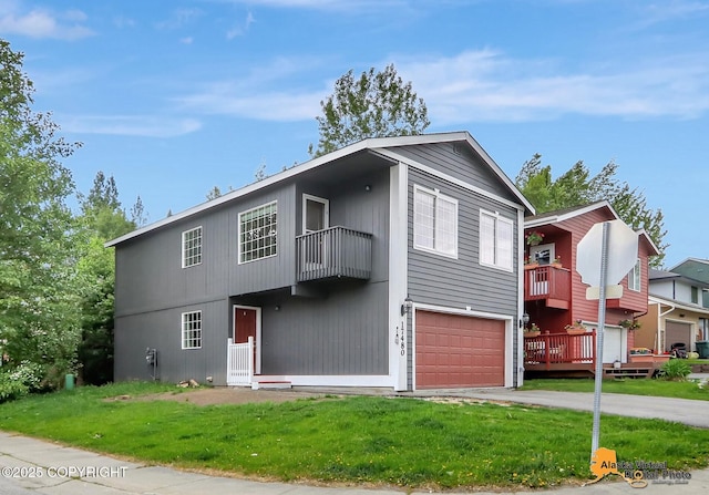 17480 Beaujolais Cir, Eagle River, AK 99577 - view of front of home with an attached garage, a balcony, a front yard, and driveway