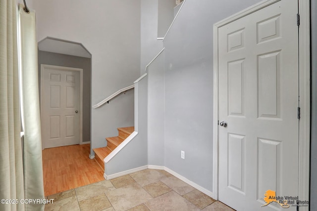 17480 Beaujolais Cir, Eagle River, AK 99577 - staircase with baseboards and stone finish floors