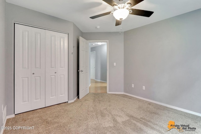 17480 Beaujolais Cir, Eagle River, AK 99577 - unfurnished bedroom featuring light carpet, a closet, baseboards, and a ceiling fan