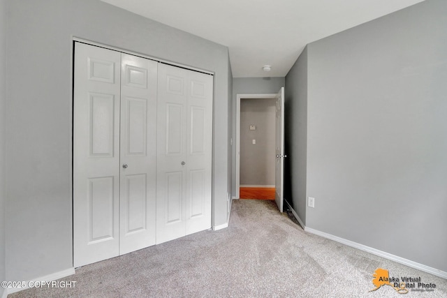 17480 Beaujolais Cir, Eagle River, AK 99577 - unfurnished bedroom featuring carpet flooring, a closet, and baseboards