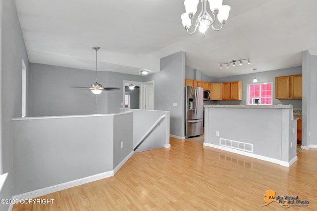 17480 Beaujolais Cir, Eagle River, AK 99577 - kitchen with appliances with stainless steel finishes, light wood-style floors, light countertops, a chandelier, and baseboards