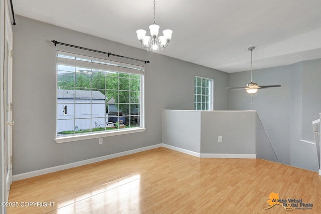17480 Beaujolais Cir, Eagle River, AK 99577 - unfurnished room featuring a chandelier, wood finished floors, healthy amount of natural light, and baseboards