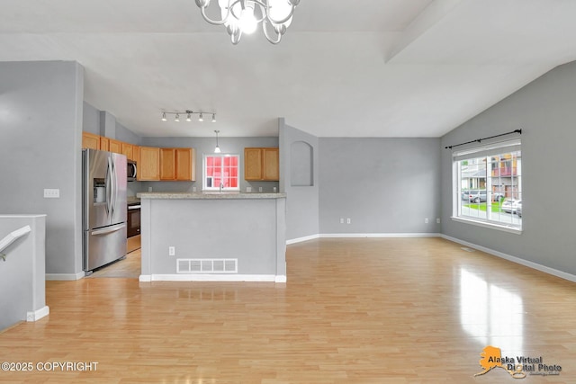 17480 Beaujolais Cir, Eagle River, AK 99577 - kitchen with stainless steel appliances, a chandelier, lofted ceiling, light wood finished floors, and light countertops