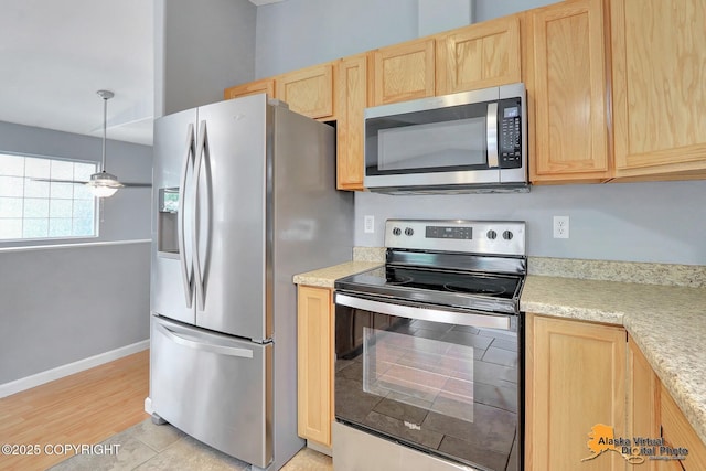 17480 Beaujolais Cir, Eagle River, AK 99577 - kitchen featuring stainless steel appliances, light brown cabinets, light countertops, and pendant lighting