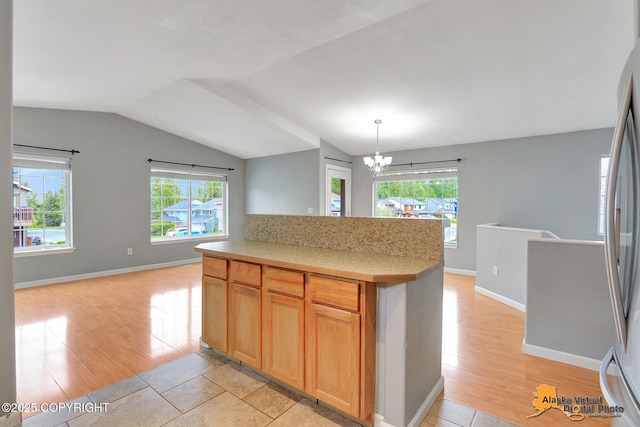 17480 Beaujolais Cir, Eagle River, AK 99577 - kitchen with lofted ceiling, a chandelier, light countertops, light wood-style flooring, and open floor plan