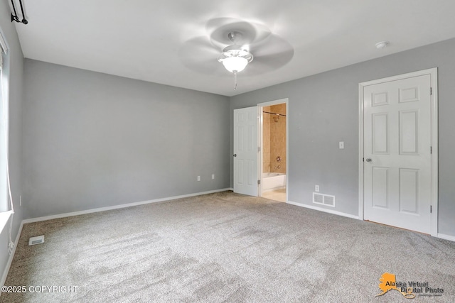17480 Beaujolais Cir, Eagle River, AK 99577 - unfurnished bedroom featuring carpet, baseboards, connected bathroom, and a ceiling fan