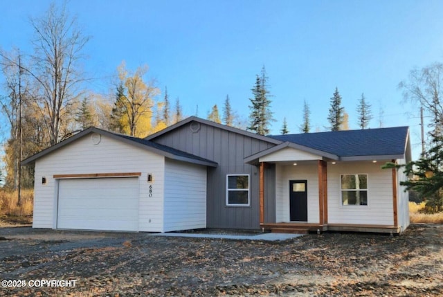 680 Wortham Ave, Kenai, AK 99611 - view of front of property featuring an attached garage, board and batten siding, and driveway