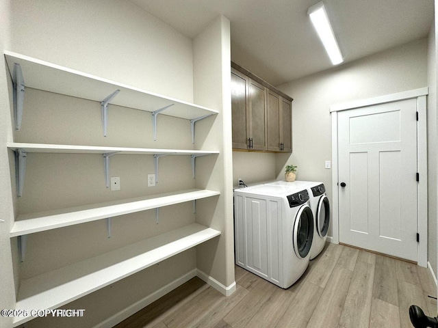 680 Wortham Ave, Kenai, AK 99611 - washroom with washing machine and clothes dryer, light wood-style floors, cabinet space, and baseboards
