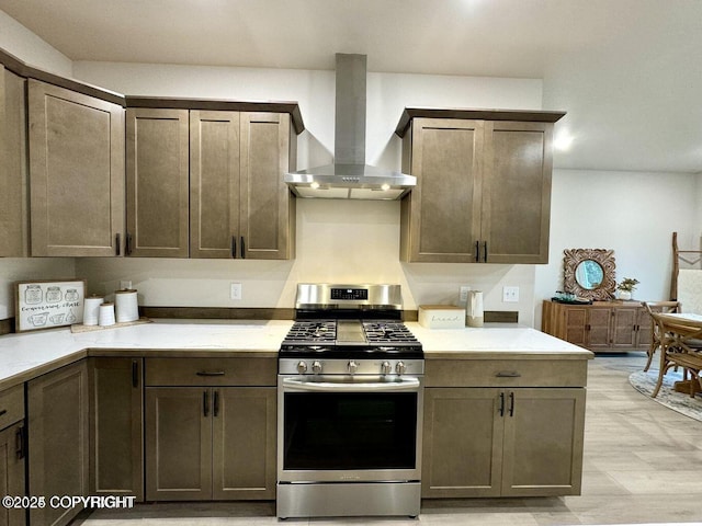 680 Wortham Ave, Kenai, AK 99611 - kitchen featuring stainless steel range with gas stovetop, wall chimney exhaust hood, and light countertops