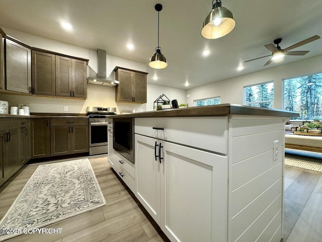 680 Wortham Ave, Kenai, AK 99611 - kitchen featuring wall chimney range hood, stainless steel range oven, a ceiling fan, light wood-style floors, and black microwave