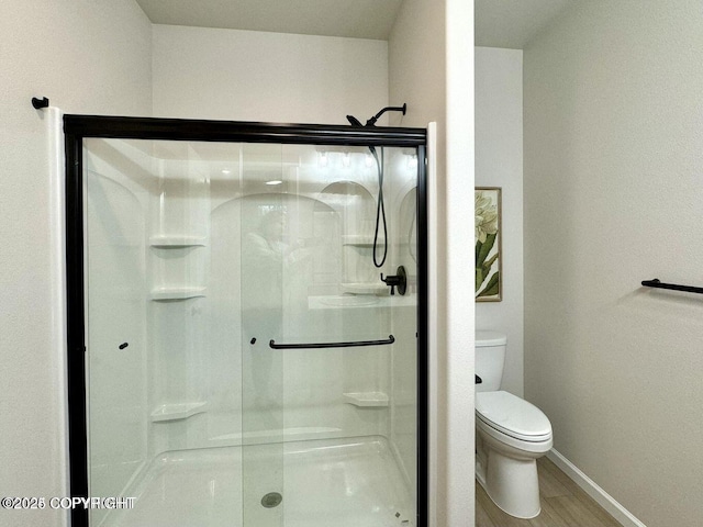 680 Wortham Ave, Kenai, AK 99611 - bathroom featuring toilet, a shower stall, baseboards, and wood finished floors