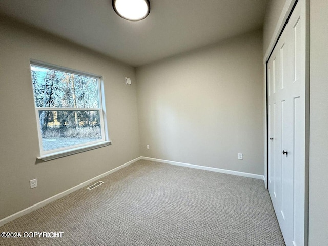 680 Wortham Ave, Kenai, AK 99611 - unfurnished bedroom with carpet floors, a closet, and baseboards