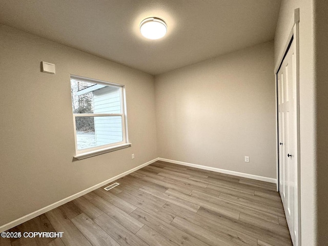 680 Wortham Ave, Kenai, AK 99611 - unfurnished bedroom with wood finished floors, baseboards, and a closet