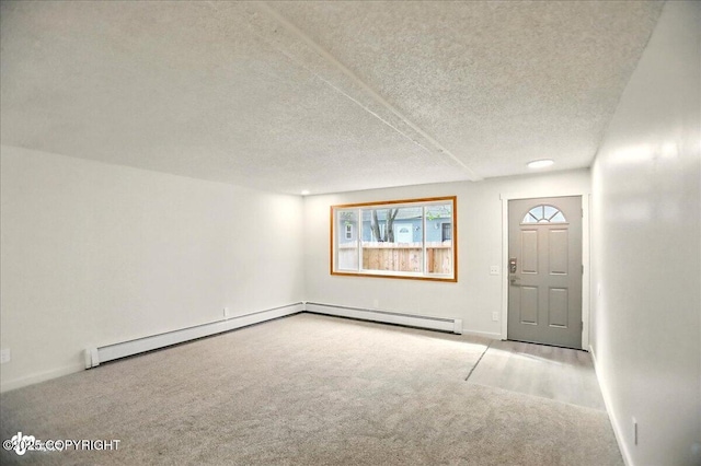 3962 Reka Dr # C1, Anchorage, AK 99508 - entryway with carpet, a textured ceiling, baseboards, and a baseboard heating unit