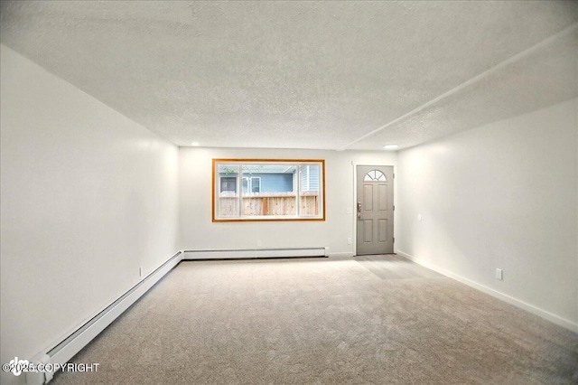 3962 Reka Dr # C1, Anchorage, AK 99508 - spare room with carpet floors, a textured ceiling, a baseboard heating unit, and baseboards