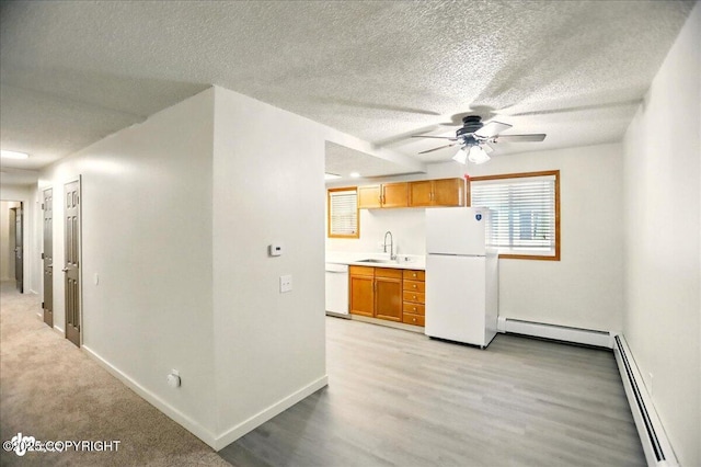 3962 Reka Dr # C1, Anchorage, AK 99508 - kitchen with white appliances, baseboard heating, a sink, a textured ceiling, and a ceiling fan