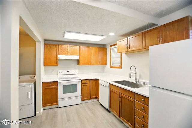 3962 Reka Dr # C1, Anchorage, AK 99508 - kitchen featuring white appliances, washer / dryer, a sink, under cabinet range hood, and light wood-style floors