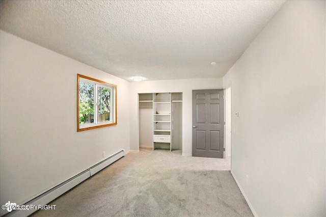 3962 Reka Dr # C1, Anchorage, AK 99508 - unfurnished bedroom featuring baseboard heating, carpet, a textured ceiling, baseboards, and a closet
