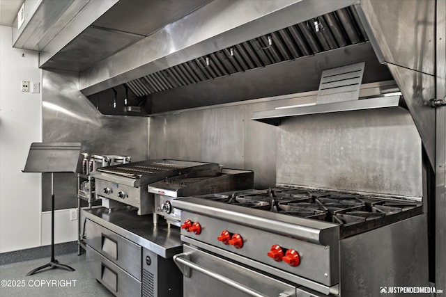 5322 S Big Lake Rd, Big Lake, AK 99652 - kitchen featuring wall chimney range hood, high end stove, and stainless steel countertops