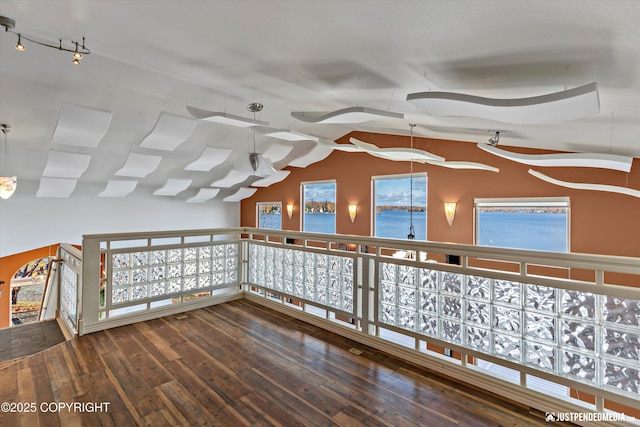 5322 S Big Lake Rd, Big Lake, AK 99652 - empty room featuring wood-type flooring, vaulted ceiling, and rail lighting
