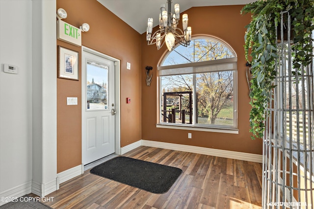 5322 S Big Lake Rd, Big Lake, AK 99652 - entryway featuring a chandelier, vaulted ceiling, and wood finished floors