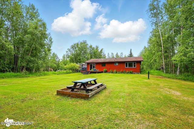 835 W Wilder Ave, Wasilla, AK 99654 - rear view of house with a lawn and a wooden deck