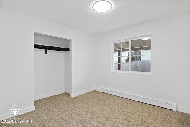 10108 Thimble Berry Dr, Anchorage, AK 99515 - unfurnished bedroom featuring a baseboard heating unit, carpet floors, a textured ceiling, baseboards, and a closet