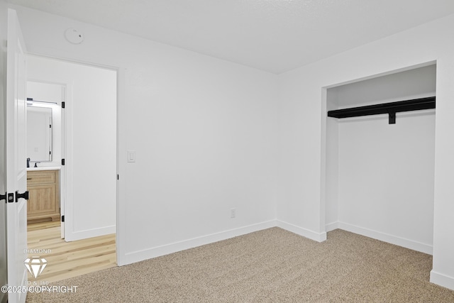 10108 Thimble Berry Dr, Anchorage, AK 99515 - unfurnished bedroom with light carpet, baseboards, and a sink