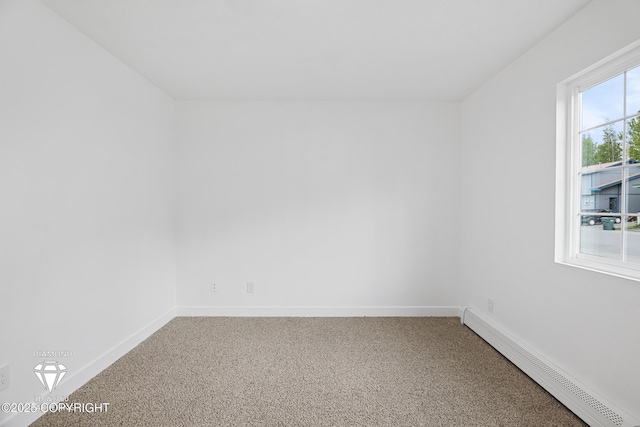 10108 Thimble Berry Dr, Anchorage, AK 99515 - empty room featuring a baseboard heating unit, carpet flooring, and baseboards