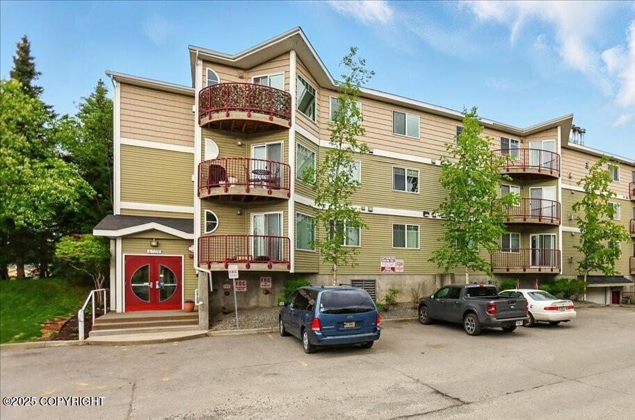 6109 Debarr Rd # 203, Anchorage, AK 99504 - view of building exterior featuring uncovered parking