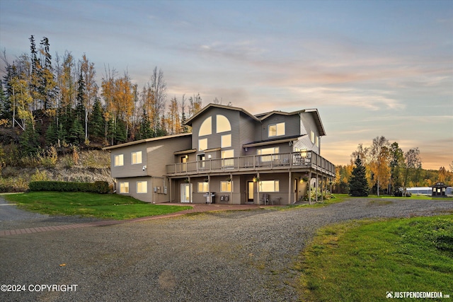 5322 S Big Lake Rd, Big Lake, AK 99623 - view of front facade featuring a yard, a deck, and driveway