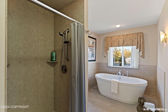 5322 S Big Lake Rd, Big Lake, AK 99623 - full bathroom with a shower with curtain, tile walls, a freestanding tub, and wainscoting