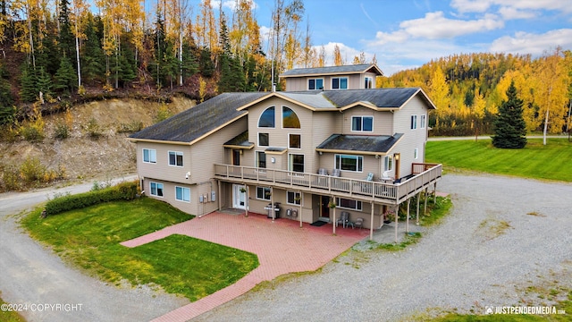 5322 S Big Lake Rd, Big Lake, AK 99623 - view of front of home featuring driveway, a wooden deck, a front lawn, and a patio area