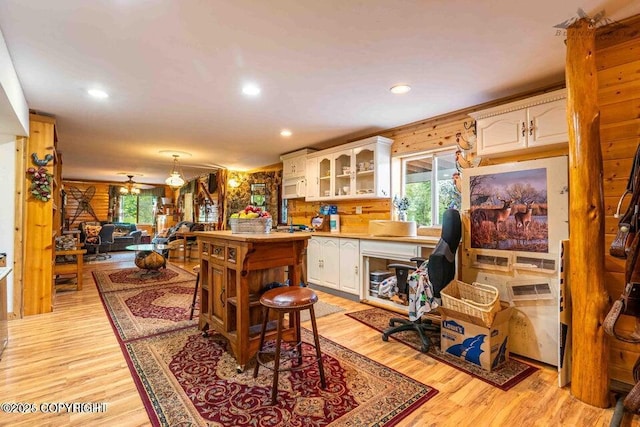 5411 Honeysuckle Ln, Wasilla, AK 99654 - kitchen with white cabinetry, light wood-type flooring, glass insert cabinets, light countertops, and an office area