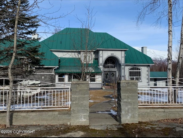 5411 Honeysuckle Ln, Wasilla, AK 99654 - view of front of property with metal roof, a fenced front yard, a standing seam roof, a chimney, and a mountain view