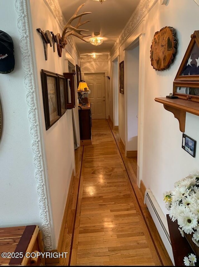 5411 Honeysuckle Ln, Wasilla, AK 99654 - hall featuring light wood-type flooring and a baseboard radiator