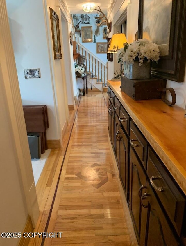 5411 Honeysuckle Ln, Wasilla, AK 99654 - hallway with light wood-type flooring, stairway, and baseboards