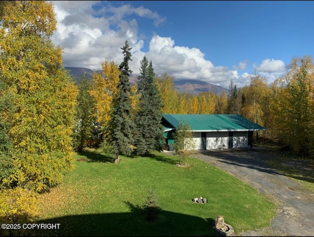 5411 Honeysuckle Ln, Wasilla, AK 99654 - view of front of house featuring a front yard, a detached garage, and a wooded view