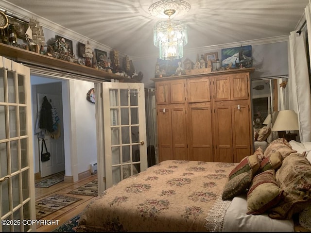 5411 Honeysuckle Ln, Wasilla, AK 99654 - bedroom with ornamental molding, wood finished floors, a chandelier, and a baseboard heating unit