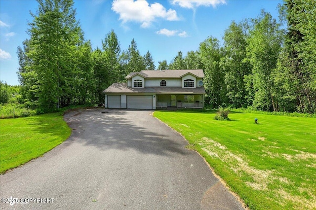 22030 Birch Creek Dr, Chugiak, AK 99567 - view of front facade featuring asphalt driveway, a front lawn, a porch, and a garage