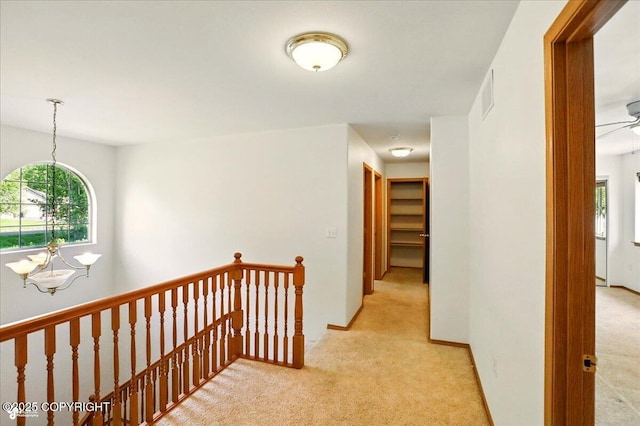 22030 Birch Creek Dr, Chugiak, AK 99567 - hall with an upstairs landing, light colored carpet, plenty of natural light, and a chandelier